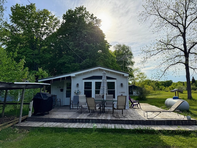 11064 S Hulbert Rd, Hulbert, MI 49748 - rear view of house featuring a wooden deck, a lawn, and an outdoor structure