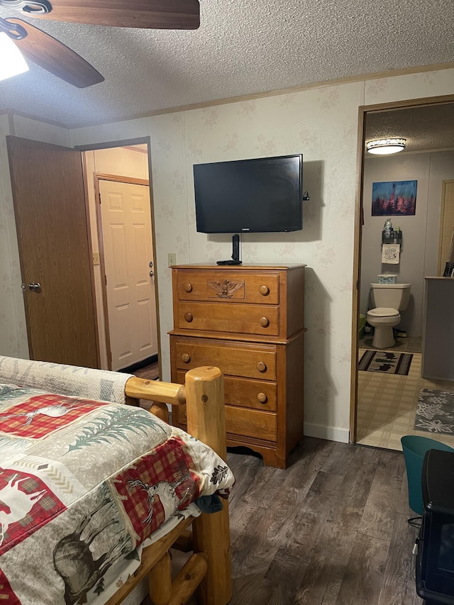 11064 S Hulbert Rd, Hulbert, MI 49748 - bedroom featuring dark wood-style floors, a textured ceiling, a ceiling fan, and ensuite bathroom