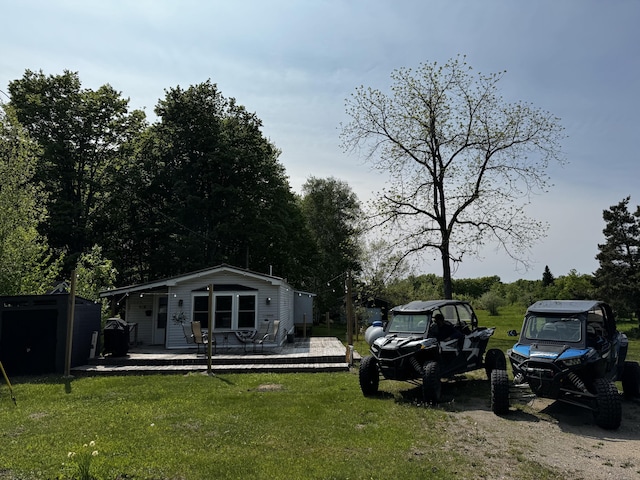 11064 S Hulbert Rd, Hulbert, MI 49748 - view of green lawn featuring an outbuilding and a wooden deck