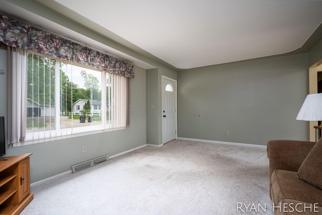 4959 Havana Ave SW, Wyoming, MI 49509 - unfurnished living room with carpet floors and baseboards