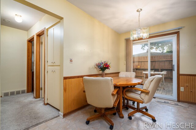 4959 Havana Ave SW, Wyoming, MI 49509 - dining area featuring wainscoting, wood walls, a chandelier, and lofted ceiling