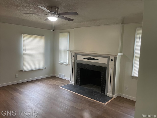 14275 Young St, Detroit, MI 48205 - unfurnished living room with a fireplace, wood finished floors, a ceiling fan, a textured ceiling, and baseboards