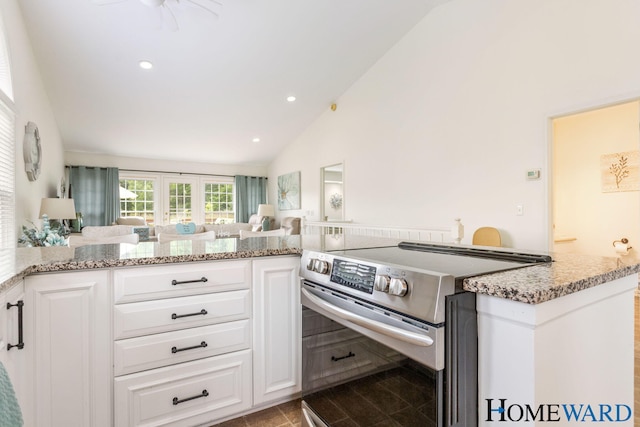 3361 English Hills Dr NW Unit 16, Grand Rapids, MI 49544 - kitchen featuring electric stove, white cabinetry, open floor plan, light stone counters, and high vaulted ceiling