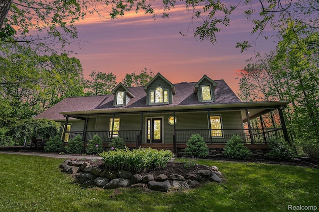8315 Woodland Cir, Goodrich, MI 48438 - farmhouse-style home with a front lawn, covered porch, and roof with shingles