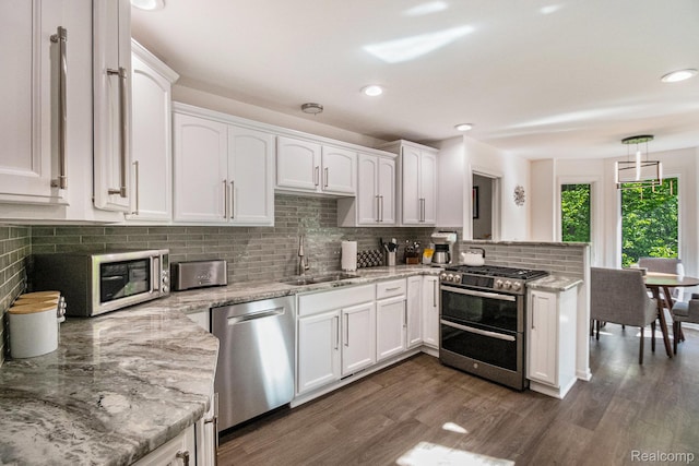 8315 Woodland Cir, Goodrich, MI 48438 - kitchen featuring stainless steel appliances, a sink, white cabinets, a peninsula, and recessed lighting