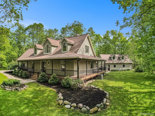 8315 Woodland Cir, Goodrich, MI 48438 - view of front of home with a front lawn, a shingled roof, a porch, central AC unit, and a chimney