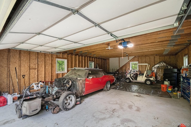 8315 Woodland Cir, Goodrich, MI 48438 - garage featuring a garage door opener