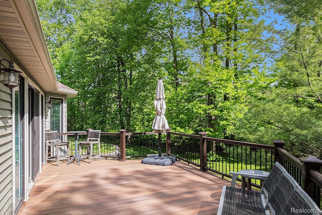 8315 Woodland Cir, Goodrich, MI 48438 - wooden deck featuring view of scattered trees