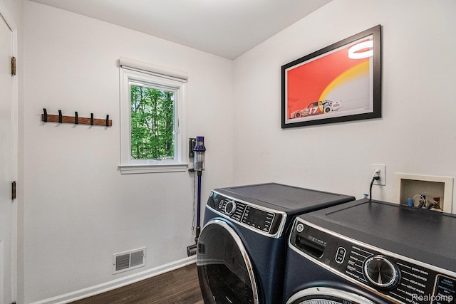 8315 Woodland Cir, Goodrich, MI 48438 - washroom with separate washer and dryer, dark wood-type flooring, and baseboards