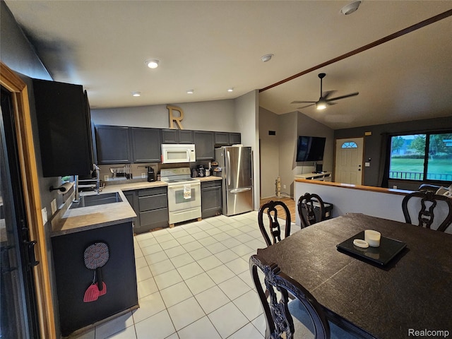 11103 Hill Rd, Swartz Creek, MI 48473 - kitchen with white appliances, lofted ceiling, light countertops, light tile patterned flooring, and a sink