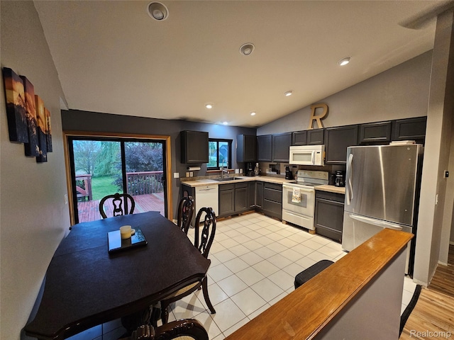 11103 Hill Rd, Swartz Creek, MI 48473 - kitchen with white appliances, light countertops, vaulted ceiling, a sink, and recessed lighting