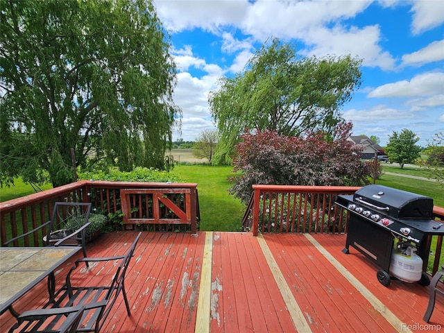 11103 Hill Rd, Swartz Creek, MI 48473 - wooden deck featuring a grill and a lawn