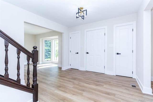 56259 Schoenherr Rd, Shelby Twp, MI 48315 - foyer entrance with light wood-style floors, baseboards, and stairs
