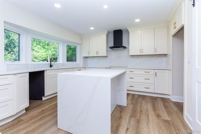 56259 Schoenherr Rd, Shelby Twp, MI 48315 - kitchen with wall chimney exhaust hood, light countertops, light wood-style flooring, white cabinets, and recessed lighting
