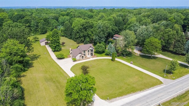 56259 Schoenherr Rd, Shelby Twp, MI 48315 - view of subject property with a heavily wooded area