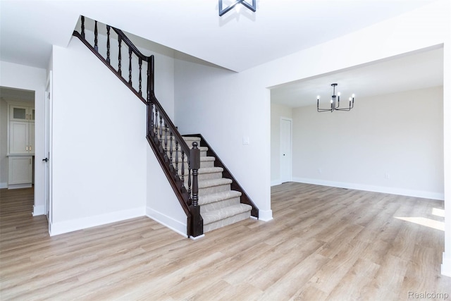 56259 Schoenherr Rd, Shelby Twp, MI 48315 - stairs with wood finished floors, a chandelier, and baseboards
