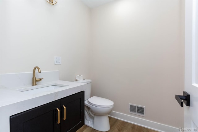 56259 Schoenherr Rd, Shelby Twp, MI 48315 - half bath with toilet, wood finished floors, vanity, and baseboards