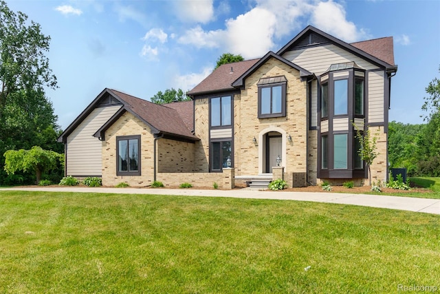 56259 Schoenherr Rd, Shelby Twp, MI 48315 - view of front facade featuring brick siding, a front yard, and central AC unit