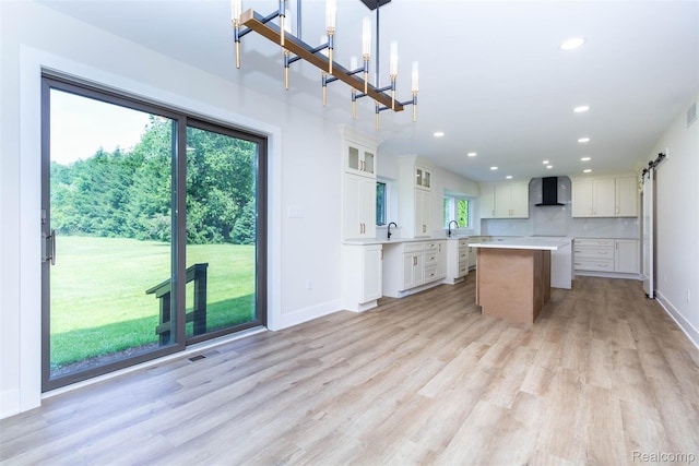 56259 Schoenherr Rd, Shelby Twp, MI 48315 - kitchen with wall chimney exhaust hood, a center island, recessed lighting, light wood-type flooring, and baseboards