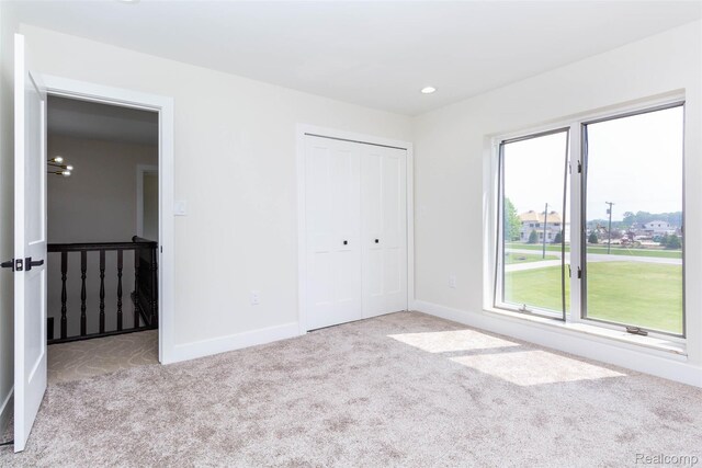 56259 Schoenherr Rd, Shelby Twp, MI 48315 - unfurnished bedroom with carpet floors, multiple windows, baseboards, a closet, and recessed lighting