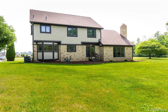 56259 Schoenherr Rd, Shelby Twp, MI 48315 - back of house featuring a yard, entry steps, a chimney, central AC unit, and brick siding