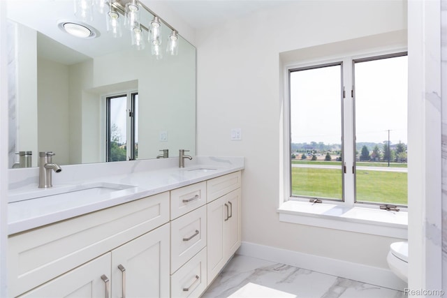 56259 Schoenherr Rd, Shelby Twp, MI 48315 - bathroom featuring double vanity, marble look tile flooring, toilet, baseboards, and a tub