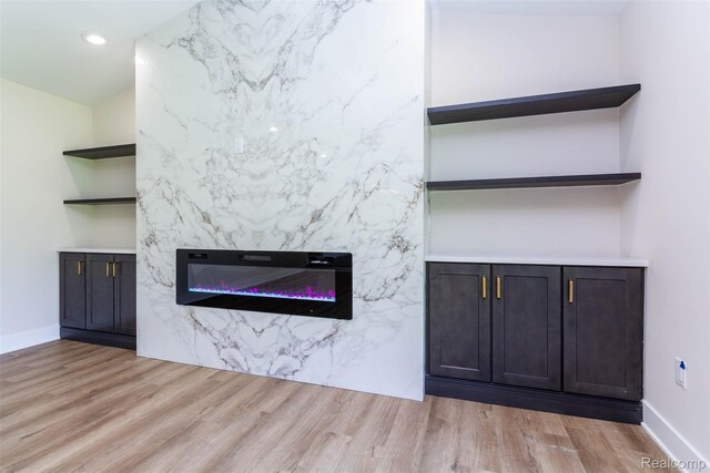 56259 Schoenherr Rd, Shelby Twp, MI 48315 - detailed view of wood finished floors, a premium fireplace, baseboards, recessed lighting, and built in shelves