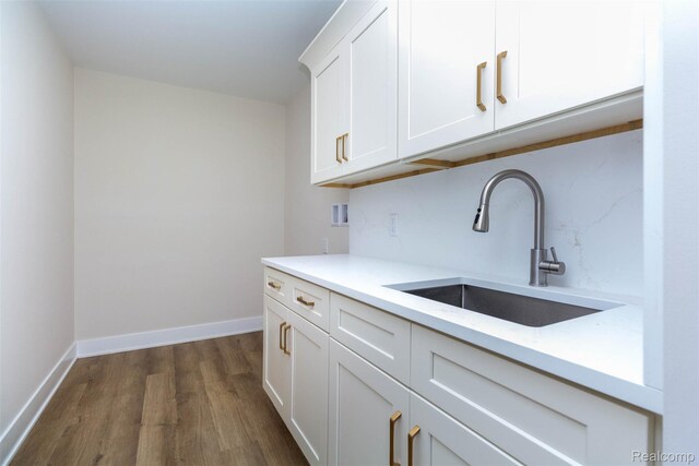 56259 Schoenherr Rd, Shelby Twp, MI 48315 - kitchen featuring a sink, dark wood-style floors, light countertops, white cabinetry, and baseboards
