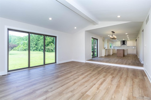 56259 Schoenherr Rd, Shelby Twp, MI 48315 - unfurnished living room featuring a chandelier, healthy amount of natural light, light wood finished floors, baseboards, and recessed lighting