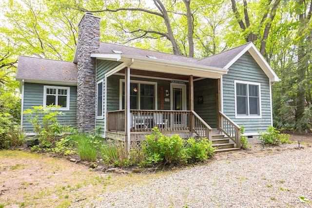 9720 Woodlawn Ave, Union Pier, MI 49129 - view of front of house with covered porch, a chimney, crawl space, and a shingled roof
