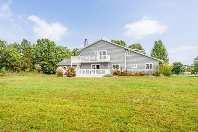 6660 Pine Rd, Benton Harbor, MI 49022 - back of house with a balcony, a chimney, and a lawn