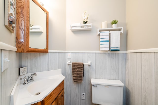 6660 Pine Rd, Benton Harbor, MI 49022 - bathroom with vanity, a wainscoted wall, and toilet