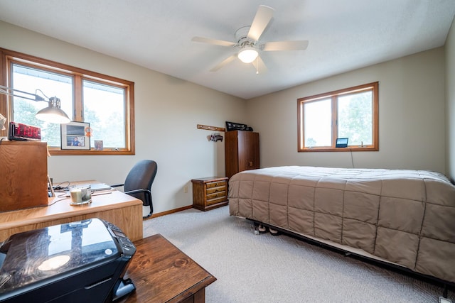6660 Pine Rd, Benton Harbor, MI 49022 - bedroom with light colored carpet, baseboards, an office area, and a ceiling fan
