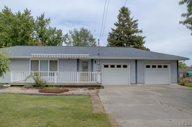 2683 Elmwood Dr, Adrian, MI 49221 - ranch-style home featuring roof with shingles, concrete driveway, a front yard, and an attached garage