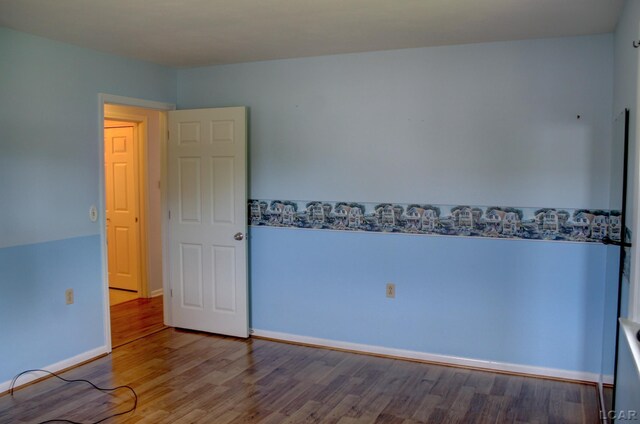 2683 Elmwood Dr, Adrian, MI 49221 - empty room with wood finished floors and baseboards