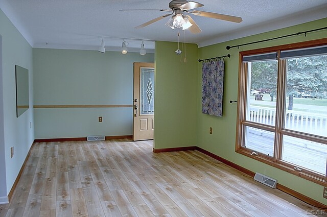 2683 Elmwood Dr, Adrian, MI 49221 - spare room with a ceiling fan, baseboards, light wood-style flooring, and track lighting