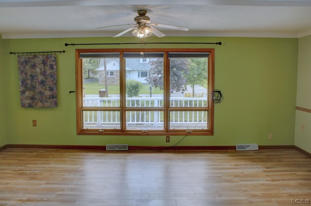 2683 Elmwood Dr, Adrian, MI 49221 - unfurnished room with plenty of natural light, ceiling fan, and light wood-type flooring