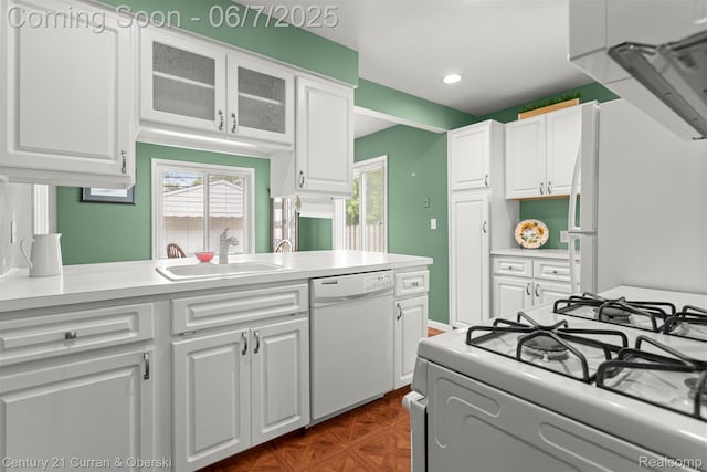 919 Whitcomb Ave, Royal Oak, MI 48073 - kitchen featuring white appliances, white cabinetry, a sink, light countertops, and glass insert cabinets