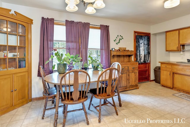 4505 E Apple Ave, Muskegon, MI 49442 - dining space featuring a chandelier and light floors