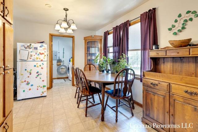 4505 E Apple Ave, Muskegon, MI 49442 - dining space featuring a chandelier, light floors, and baseboards