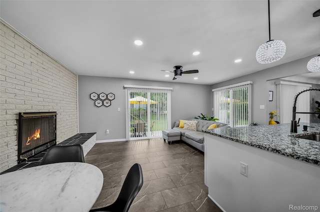 24970 Thorndyke St, Southfield, MI 48033 - living room featuring recessed lighting, a fireplace, and a ceiling fan