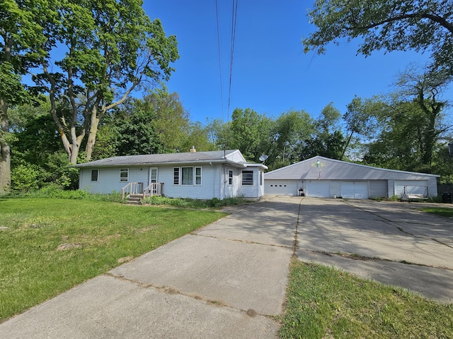 607 66th St SE, Grand Rapids, MI 49548 - view of front of home with a detached garage, a front yard, and an outdoor structure