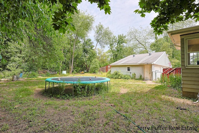 607 66th St SE, Grand Rapids, MI 49548 - view of yard featuring a trampoline and an outdoor structure