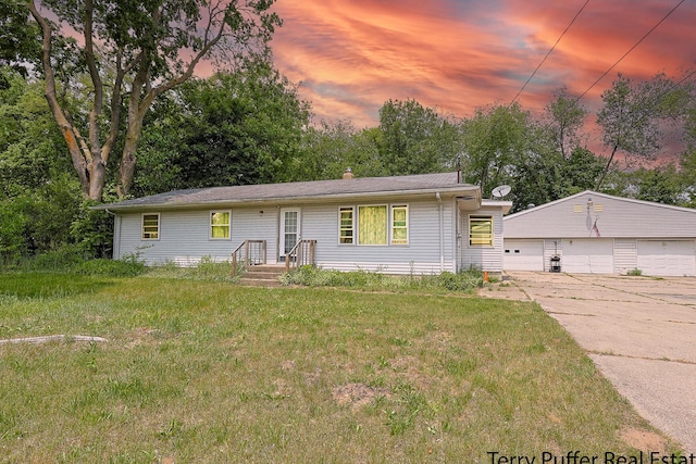 607 66th St SE, Grand Rapids, MI 49548 - ranch-style home with a detached garage, an outdoor structure, a front lawn, and view of scattered trees
