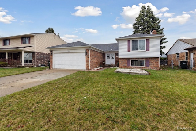 13439 Brougham Dr, Warren, MI 48312 - split level home featuring an attached garage, driveway, brick siding, and a chimney