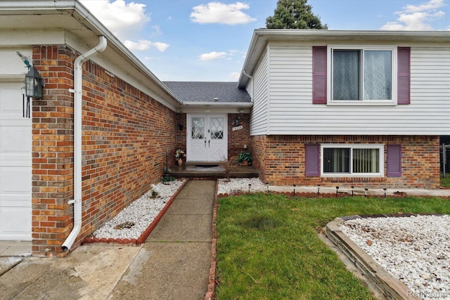 13439 Brougham Dr, Warren, MI 48312 - doorway to property featuring brick siding, a garage, and a lawn