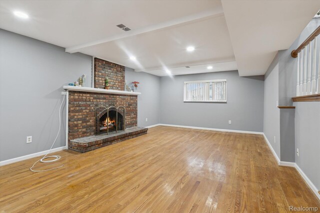 13439 Brougham Dr, Warren, MI 48312 - unfurnished living room featuring wood finished floors, a brick fireplace, baseboards, and recessed lighting
