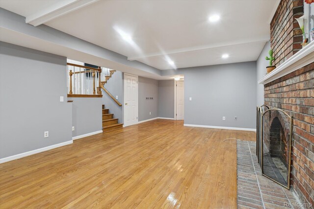 13439 Brougham Dr, Warren, MI 48312 - unfurnished living room featuring baseboards, stairs, a fireplace, light wood-type flooring, and recessed lighting