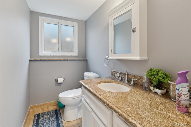 13439 Brougham Dr, Warren, MI 48312 - half bath with vanity, toilet, baseboards, and wood finished floors