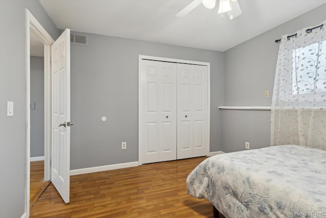 13439 Brougham Dr, Warren, MI 48312 - bedroom with wood finished floors, a closet, baseboards, and a ceiling fan